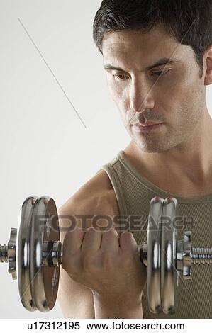 Man using free weights View Large Photo Image Stock Photography - Man using free weights. Fotosearch