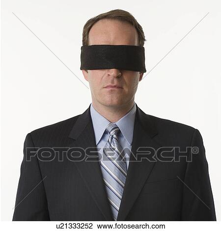 Stock Image - Man wearing blindfold. Fotosearch