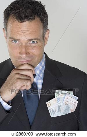 Man with a pocketful of Euros View Large Photo Image Stock Photo - Man with a pocketful of Euros. Fotosearch