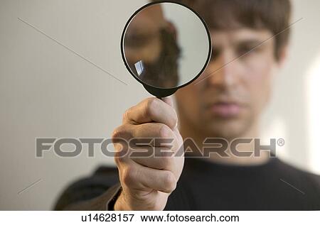 Stock Photo - Man with magnifying glass. Fotosearch
