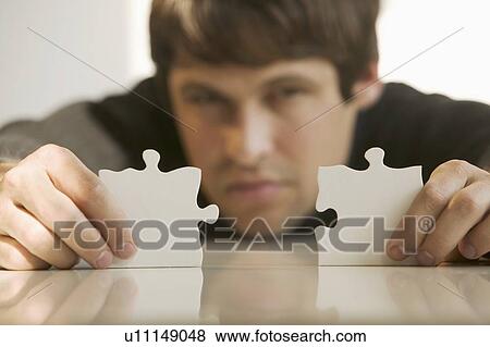 Man with puzzle pieces View Large Photo Image Stock Photo - Man with puzzle pieces. Fotosearch