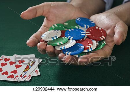 Picture - Man with winning poker hand. Fotosearch