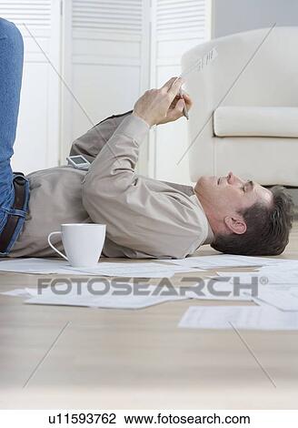 Man writing while lying on floor View Large Photo Image Stock Image - Man writing while lying on floor. Fotosearch