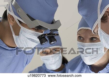 Stock Image - Medical team in surgery. Fotosearch
