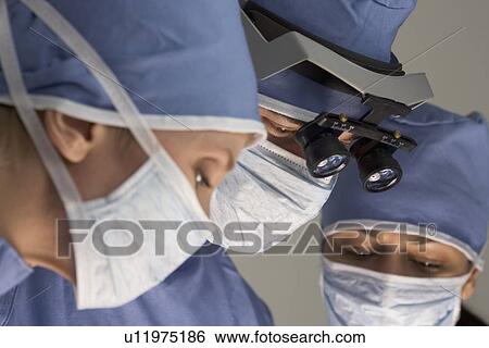 Stock Photograph - Medical team in surgery. Fotosearch
