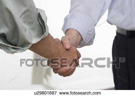 Stock Photo - Men in shirtsleeves shaking hands. Fotosearch
