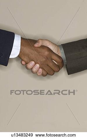 Stock Photo - Men shaking hands. Fotosearch