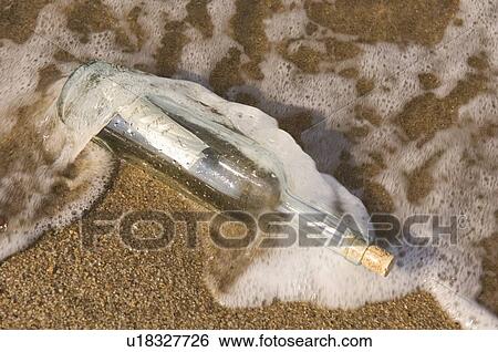 Message in bottle washing up on shore View Large Photo Image Stock Photograph - Message in bottle washing up on shore. Fotosearch