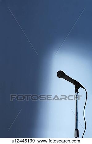 Microphone and stand on an empty stage View Large Photo Image Stock Photo - Microphone and stand on an empty stage. Fotosearch