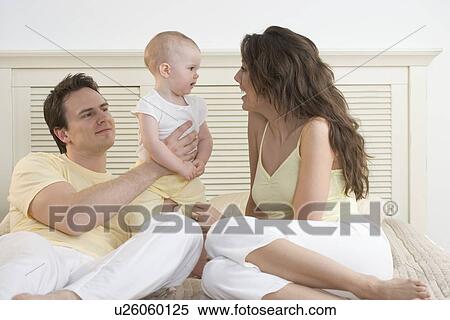Mom talking to baby with dad View Large Photo Image Stock Photography - Mom talking to baby with dad. Fotosearch