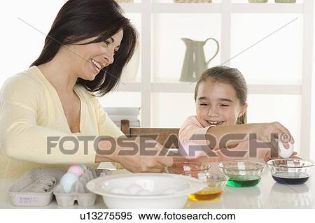 Mother and daughter coloring Easter eggs View Large Photo Image Stock Photography - Mother and daughter coloring Easter eggs. Fotosearch