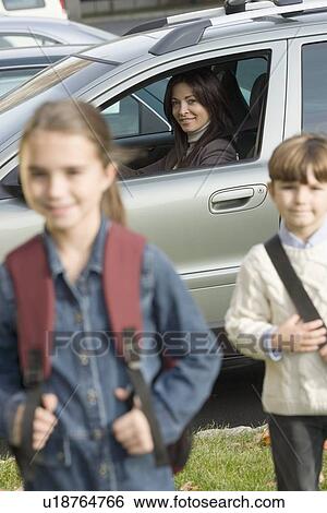 Stock Photograph - Mother dropping children off at school. Fotosearch