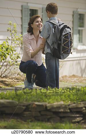 Mother seeing young son off to school View Large Photo Image Stock Image - Mother seeing young son off to school. Fotosearch