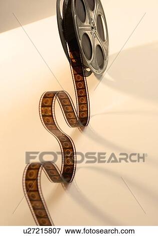Movie film reel unrolling from above View Large Photo Image Stock Photo - Movie film reel unrolling from above. Fotosearch