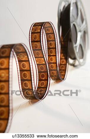 Movie film reel unrolling View Large Photo Image Stock Image - Movie film reel unrolling. Fotosearch