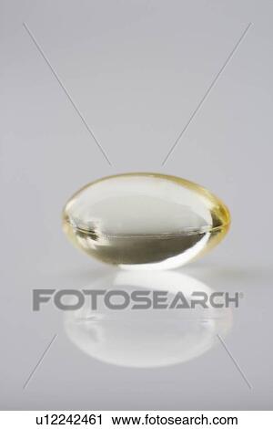 Stock Image - One gelcap and its reflection. Fotosearch