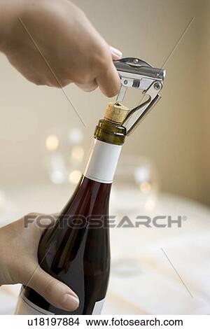Opening a bottle of wine View Large Photo Image Picture - Opening a bottle of wine. Fotosearch