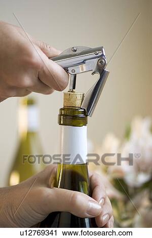 Opening a bottle of wine View Large Photo Image Stock Image - Opening a bottle of wine. Fotosearch
