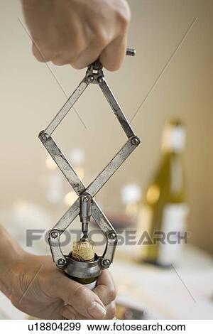 Stock Photo - Opening a bottle of wine. Fotosearch