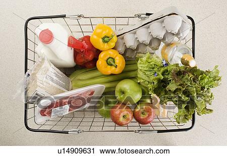 Stock Image - Overhead view of groceries in basket. Fotosearch