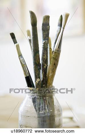 Stock Image - Paintbrushes in glass jar. Fotosearch