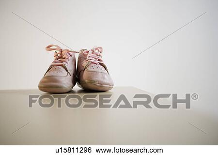 Stock Photograph - Pair of baby shoes on table. Fotosearch