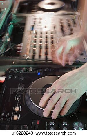 Person mixing music in a nightclub View Large Photo Image Stock Image - Person mixing music in a nightclub. Fotosearch