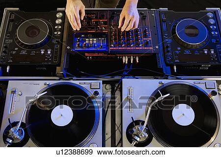 Stock Photo - Person mixing music in a nightclub. Fotosearch