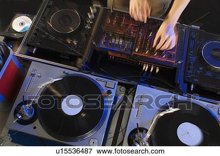 Person mixing music in a nightclub View Large Photo Image Stock Photo - Person mixing music in a nightclub. Fotosearch