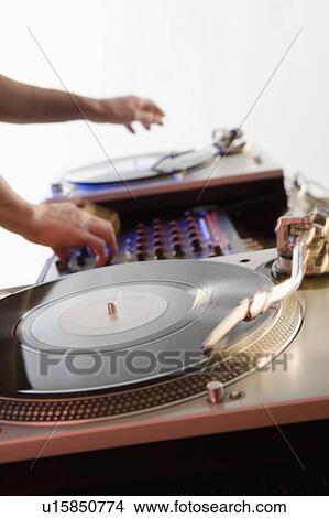 Person mixing sound from records View Large Photo Image Picture - Person mixing sound from records. Fotosearch
