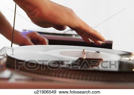 Stock Photo - Person mixing sound from records. Fotosearch