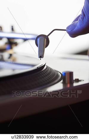 Person setting needle on a record View Large Photo Image Stock Photo - Person setting needle on a record. Fotosearch