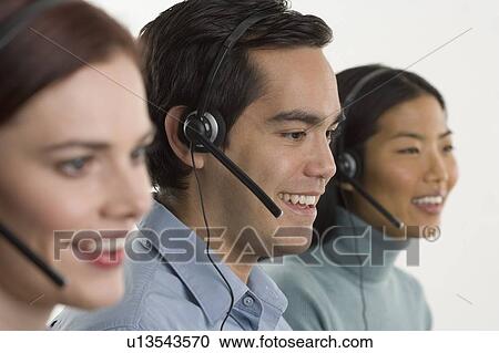 Phone operators using headsets View Large Photo Image Stock Image - Phone operators using headsets. Fotosearch