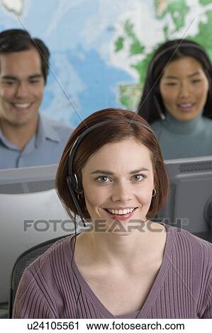 Stock Image - Phone operators using headsets. Fotosearch