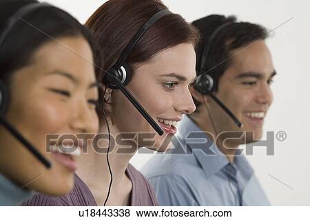 Phone operators using headsets View Large Photo Image Stock Photo - Phone operators using headsets. Fotosearch