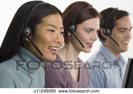 Phone operators using headsets View Large Photo Image Stock Photography - Phone operators using headsets. Fotosearch