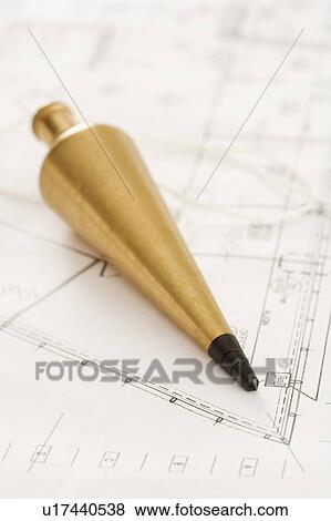Plumb bob with blueprints View Large Photo Image Stock Photo - Plumb bob with blueprints. Fotosearch