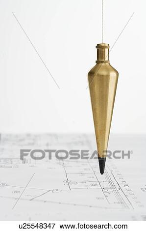 Plumb bob with blueprints View Large Photo Image Stock Photo - Plumb bob with blueprints. Fotosearch