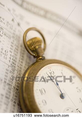 Stock Image - Pocket watch and stock figures. Fotosearch