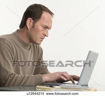 Stock Photography - Portrait of a man at his computer. Fotosearch