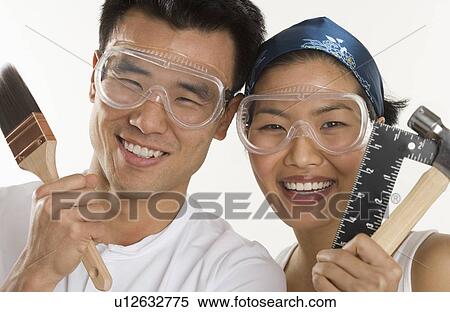 Stock Photography - Portrait of couple doing home repairs. Fotosearch