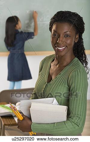 Stock Image - Portrait of female teacher. Fotosearch