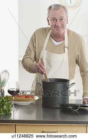 Portrait of man cooking View Large Photo Image Stock Photography - Portrait of man cooking. Fotosearch
