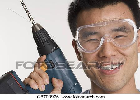 Portrait of man with electric drill View Large Photo Image Stock Photograph - Portrait of man with electric drill. Fotosearch