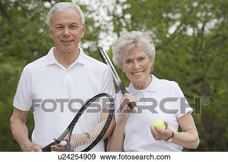 Portrait of mature couple with tennis racquets View Large Photo Image Stock Photo - Portrait of mature couple with tennis racquets. Fotosearch
