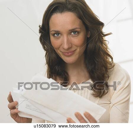 Portrait of woman holding mail View Large Photo Image Stock Photo - Portrait of woman holding mail. Fotosearch