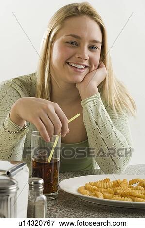 Stock Photo - Portrait of woman in a diner. Fotosearch