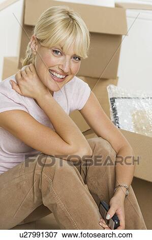 Stock Photo - Portrait of woman on moving day. Fotosearch