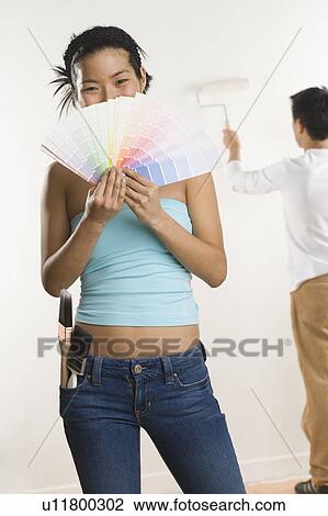 Stock Image - Portrait of woman with color samples. Fotosearch