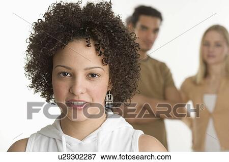 Portrait of young woman with two friends View Large Photo Image Stock Photo - Portrait of young woman with two friends. Fotosearch
